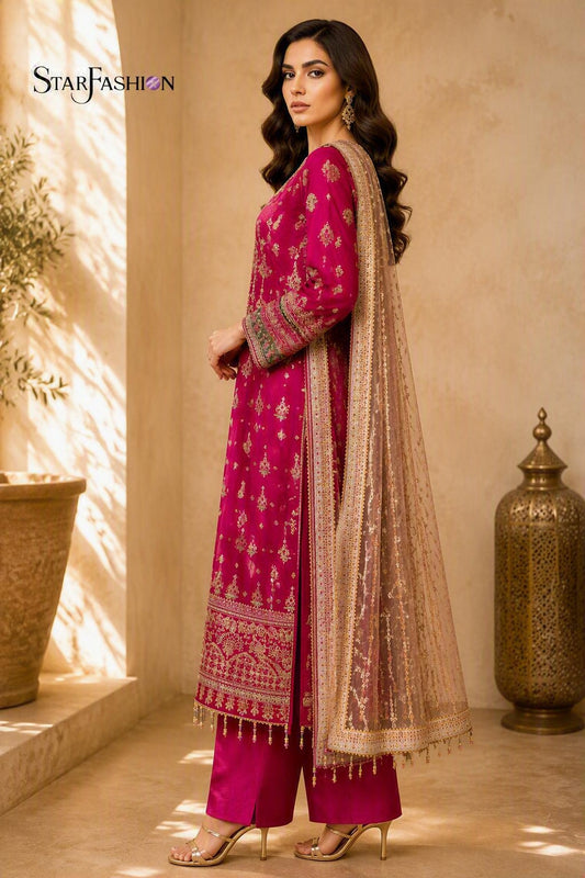 Shocking pink embroidered chiffon straight suit with intricate embroidery, elegant net dupatta, and silk trousers, showcasing luxurious Pakistani ethnic fashion for festive and formal occasions.