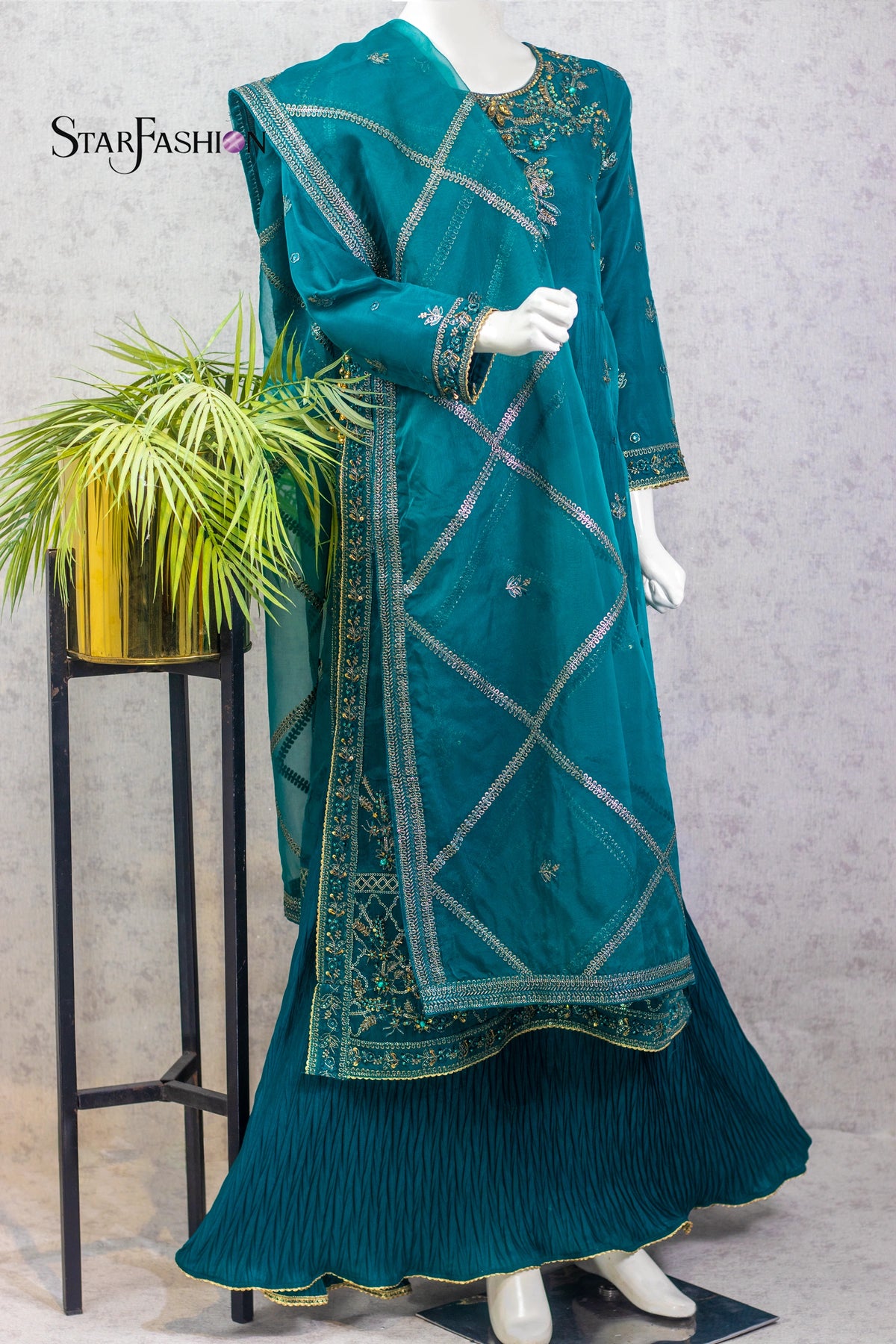 A luxurious 4‑piece stitched gown style outfit available in berry and sea green color variations. Featuring a malai embroidered inner shirt with a crushed style, paired with an embroidered organza over‑layered shirt, straight malai trousers, and a flowing embroidered organza dupatta. Designed in a regular fit, this ensemble is perfect for festive occasions, weddings, and luxury party wear.