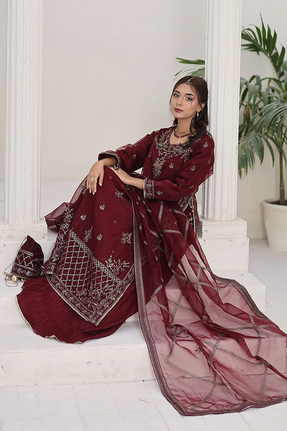A luxurious 4‑piece stitched gown style outfit available in berry and sea green color variations. Featuring a malai embroidered inner shirt with a crushed style, paired with an embroidered organza over‑layered shirt, straight malai trousers, and a flowing embroidered organza dupatta. Designed in a regular fit, this ensemble is perfect for festive occasions, weddings, and luxury party wear.