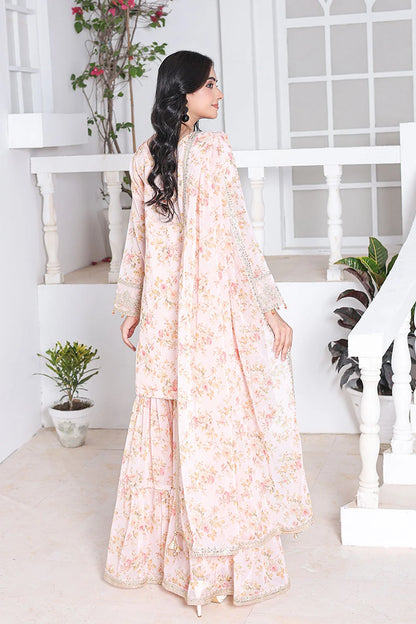 Woman in a floral dress standing in a bright, minimalistic room with white walls and a staircase.