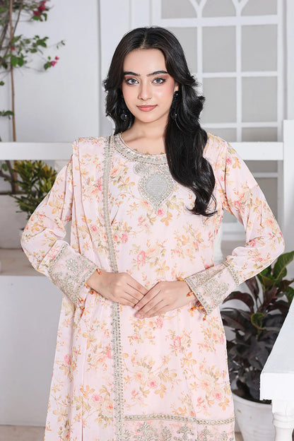 Woman wearing a floral dress with intricate patterns in a bright indoor setting