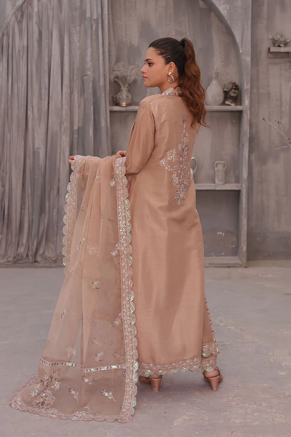 "Elegant coral pink raw silk tunic and wide‑leg trouser styled with embroidered organza dupatta"