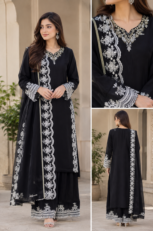 A woman modeling a black traditional outfit with extensive white and silver embroidery, shown in a three-panel collage including a full front view, a close-up of the neckline, and a back view. The setting is a neutral outdoor architectural walkway.