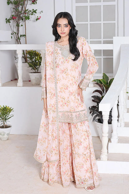 Woman wearing a floral dress in a white room with plants