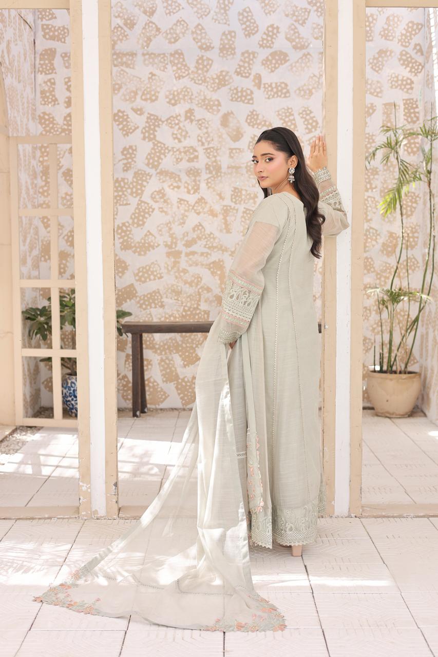 "Delicate embroidery on sea green khaddi shirt and Russian silk koti – luxury stitched suit"