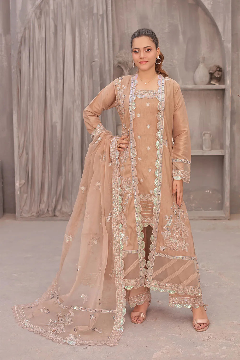 Coral pink embroidered 4-piece Pakistani suit featuring an open-style raw silk long shrug, straight-cut raw silk kurta with an embroidered neckline, raw silk palazzo with embroidered bottoms, and an embroidered organza dupatta.