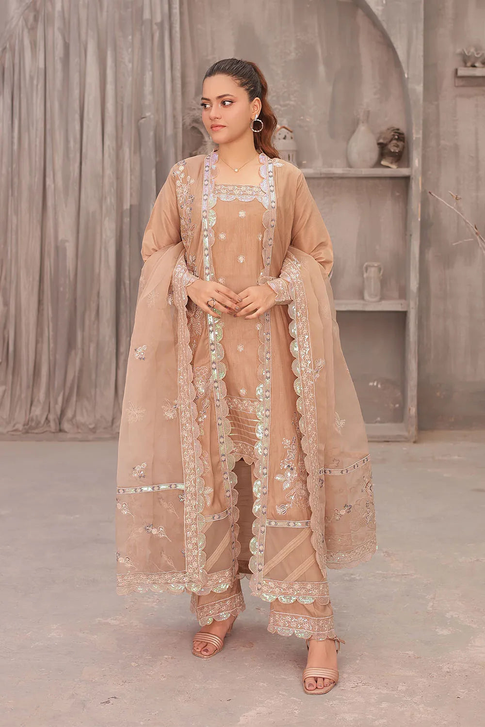 Coral pink embroidered 4-piece Pakistani suit featuring an open-style raw silk long shrug, straight-cut raw silk kurta with an embroidered neckline, raw silk palazzo with embroidered bottoms, and an embroidered organza dupatta.