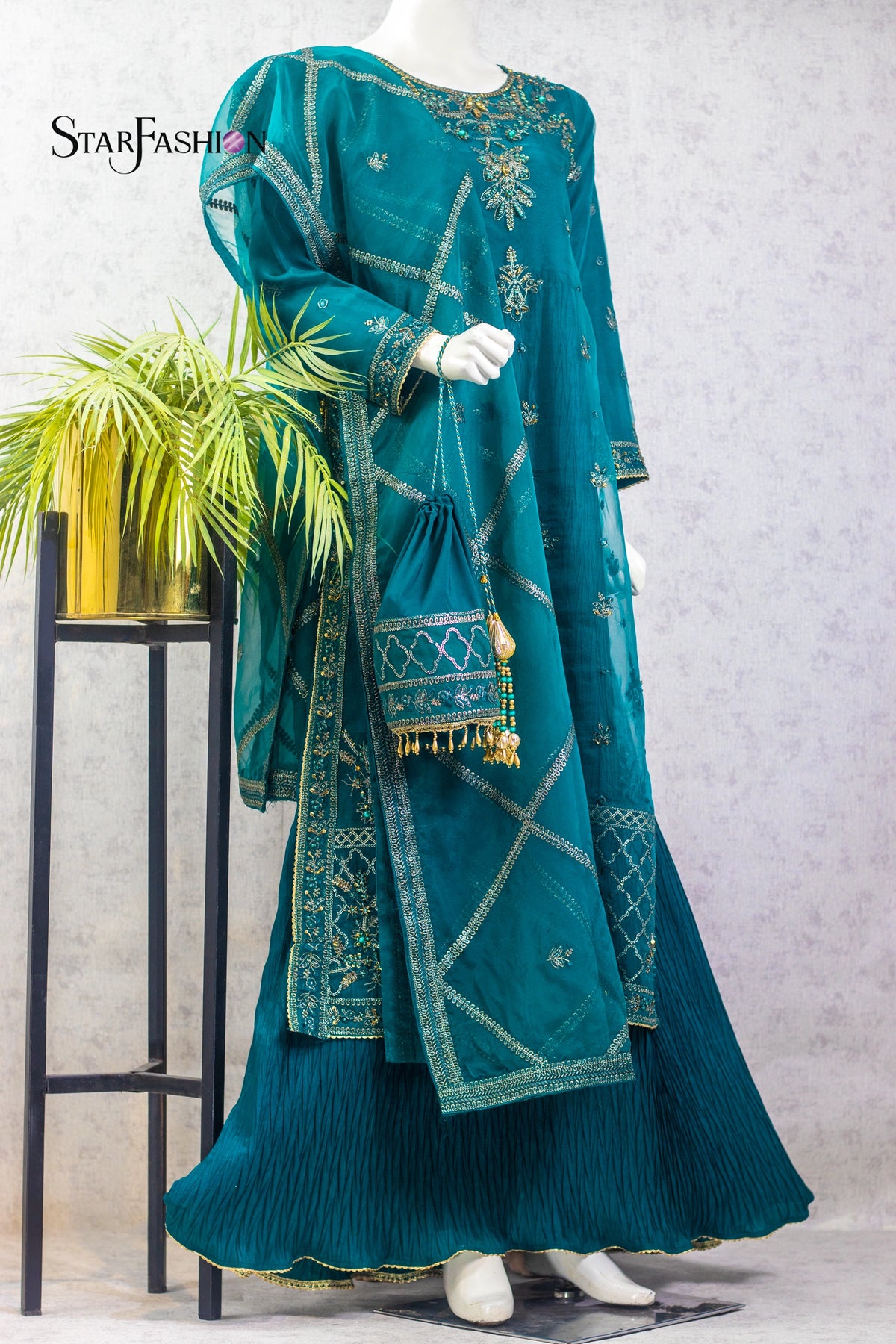 "Elevate your festive wardrobe with this embroidered 4‑piece gown style ensemble in berry and sea green. Featuring a malai inner, organza overcoat, trousers, and dupatta, perfect for weddings and luxury party wear."