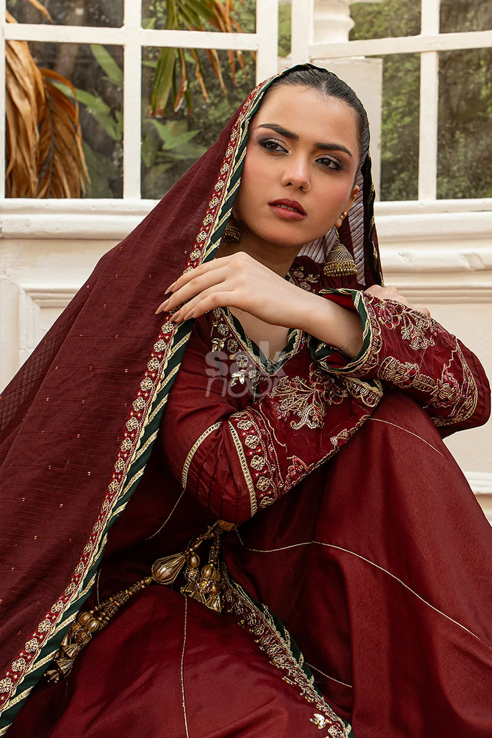 Maroon embroidered 3-piece Pakistani suit featuring a Shamus silk Angrakha frock with full Malai lining, matching Shamus silk palazzo trousers, and a self-Khaddi dupatta
