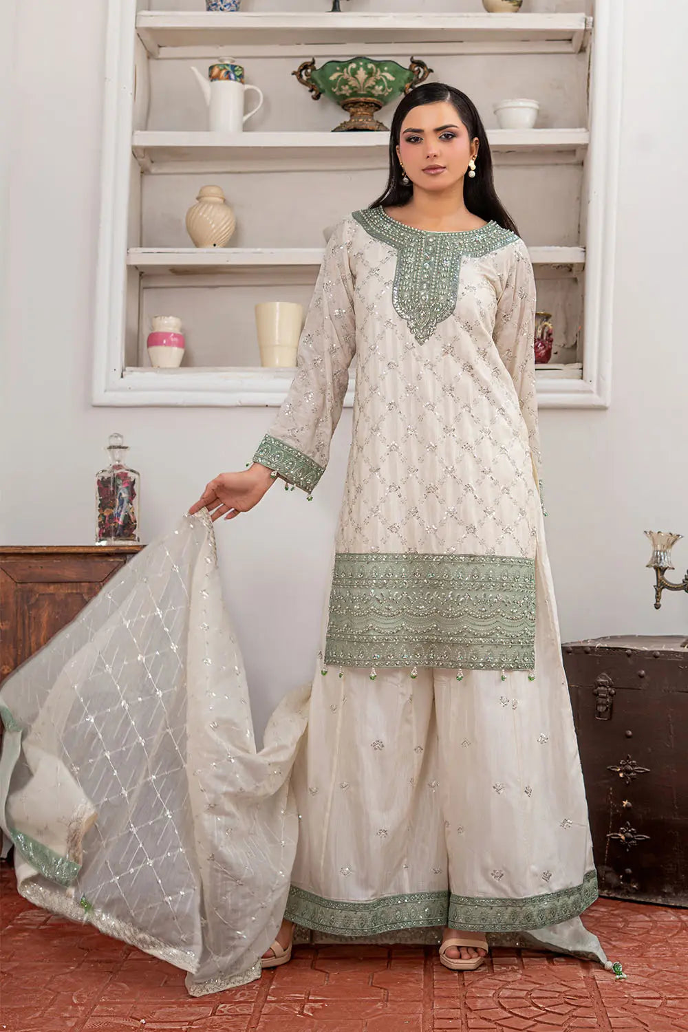 Off-white embroidered 3-piece Pakistani suit featuring a short Bana Dora kurta with Malai lining, matching Kali palazzo, and Khaddi Net dupatta