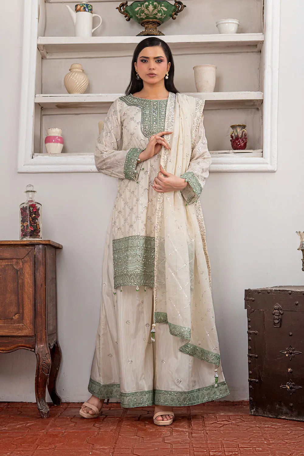 Off-white embroidered 3-piece Pakistani suit featuring a short Bana Dora kurta with Malai lining, matching Kali palazzo, and Khaddi Net dupatta