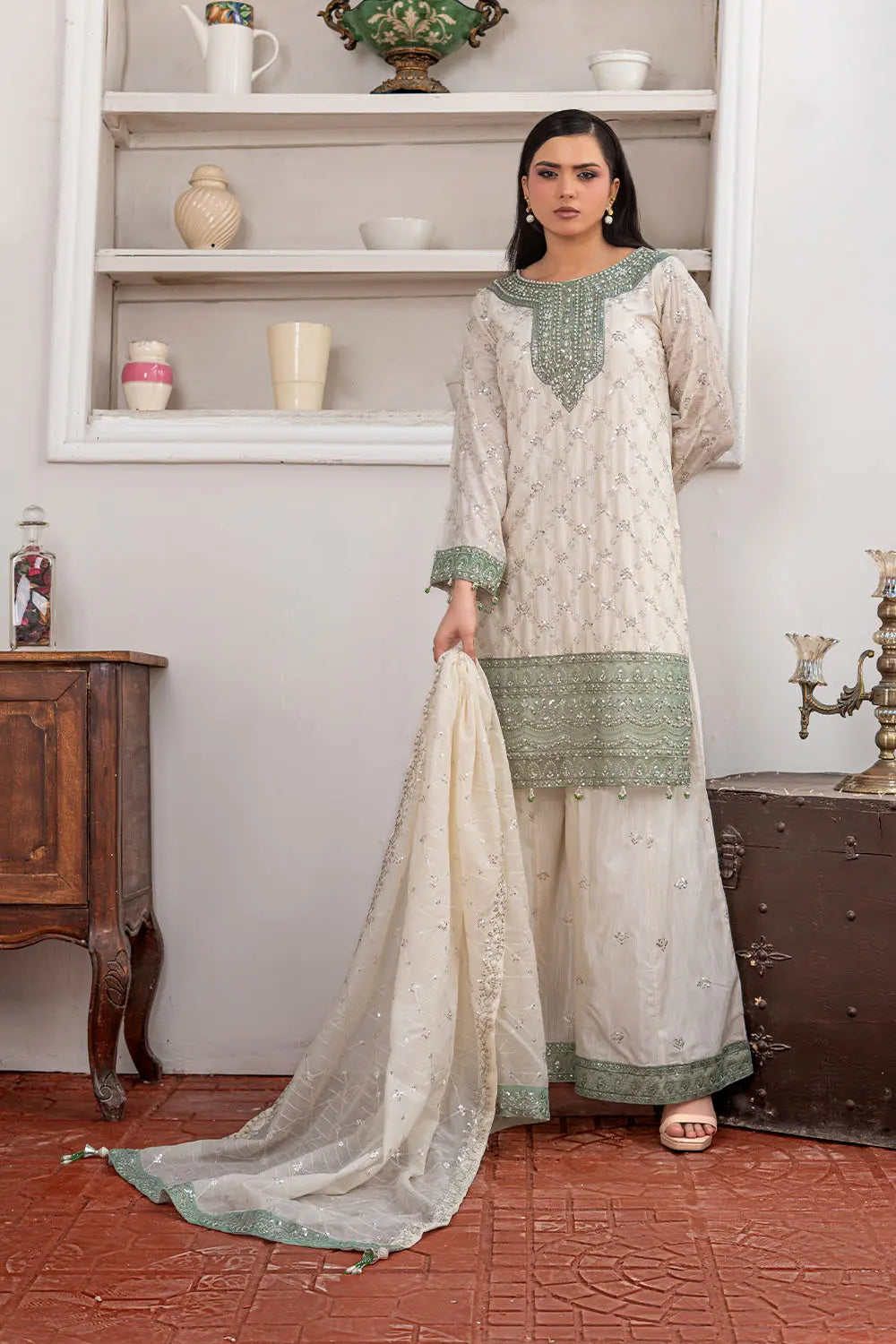 Off-white embroidered 3-piece Pakistani suit featuring a short Bana Dora kurta with Malai lining, matching Kali palazzo, and Khaddi Net dupatta