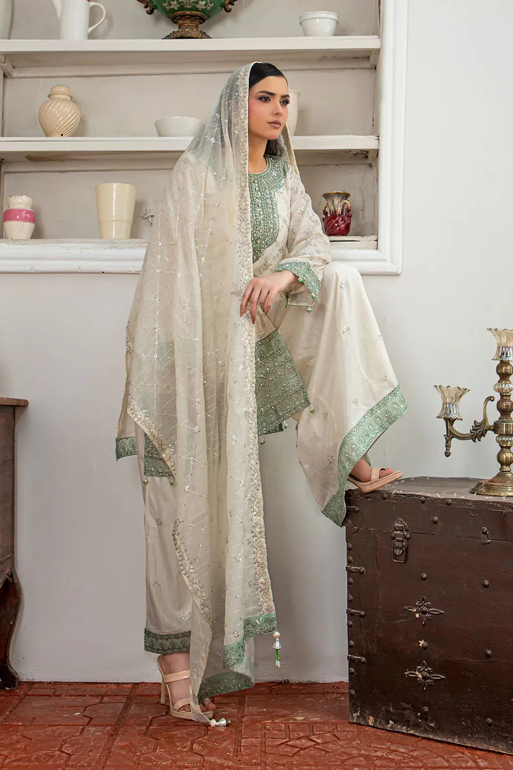Off-white embroidered 3-piece Pakistani suit featuring a short Bana Dora kurta with Malai lining, matching Kali palazzo, and Khaddi Net dupatta