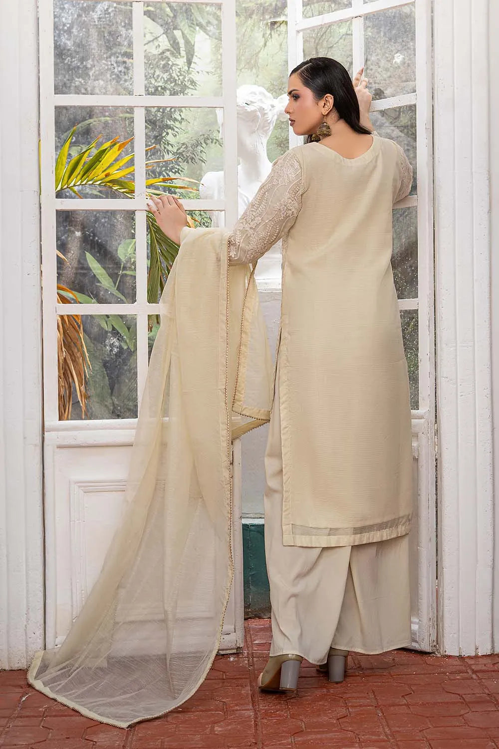 Off-white embroidered 3-piece Pakistani suit featuring a straight-cut organza kurta with full lining, Grip palazzo trousers, and a Khaddi Net dupatta.