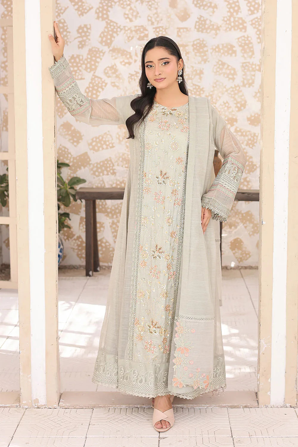 Pistachio three-piece embroidered frock featuring Khaddi Net fabric, full lining, Crepe straight trousers, and a matching Khaddi Net dupatta.
