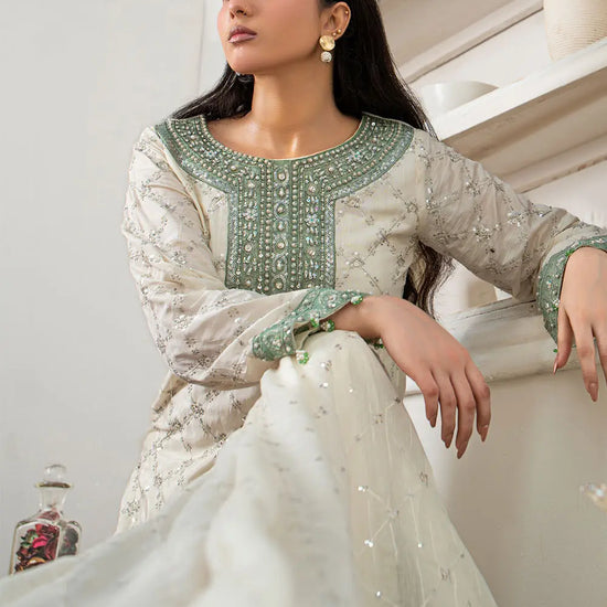Off-white embroidered 3-piece Pakistani suit featuring a short Bana Dora kurta with Malai lining, matching Kali palazzo, and Khaddi Net dupatta