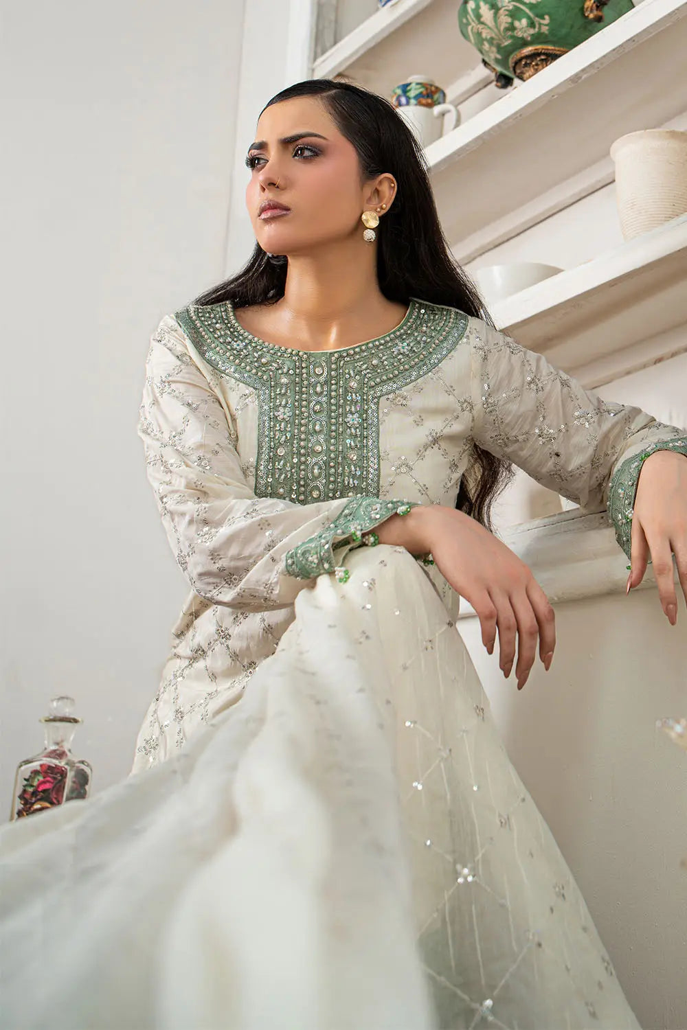 Off-white embroidered 3-piece Pakistani suit featuring a short Bana Dora kurta with Malai lining, matching Kali palazzo, and Khaddi Net dupatta