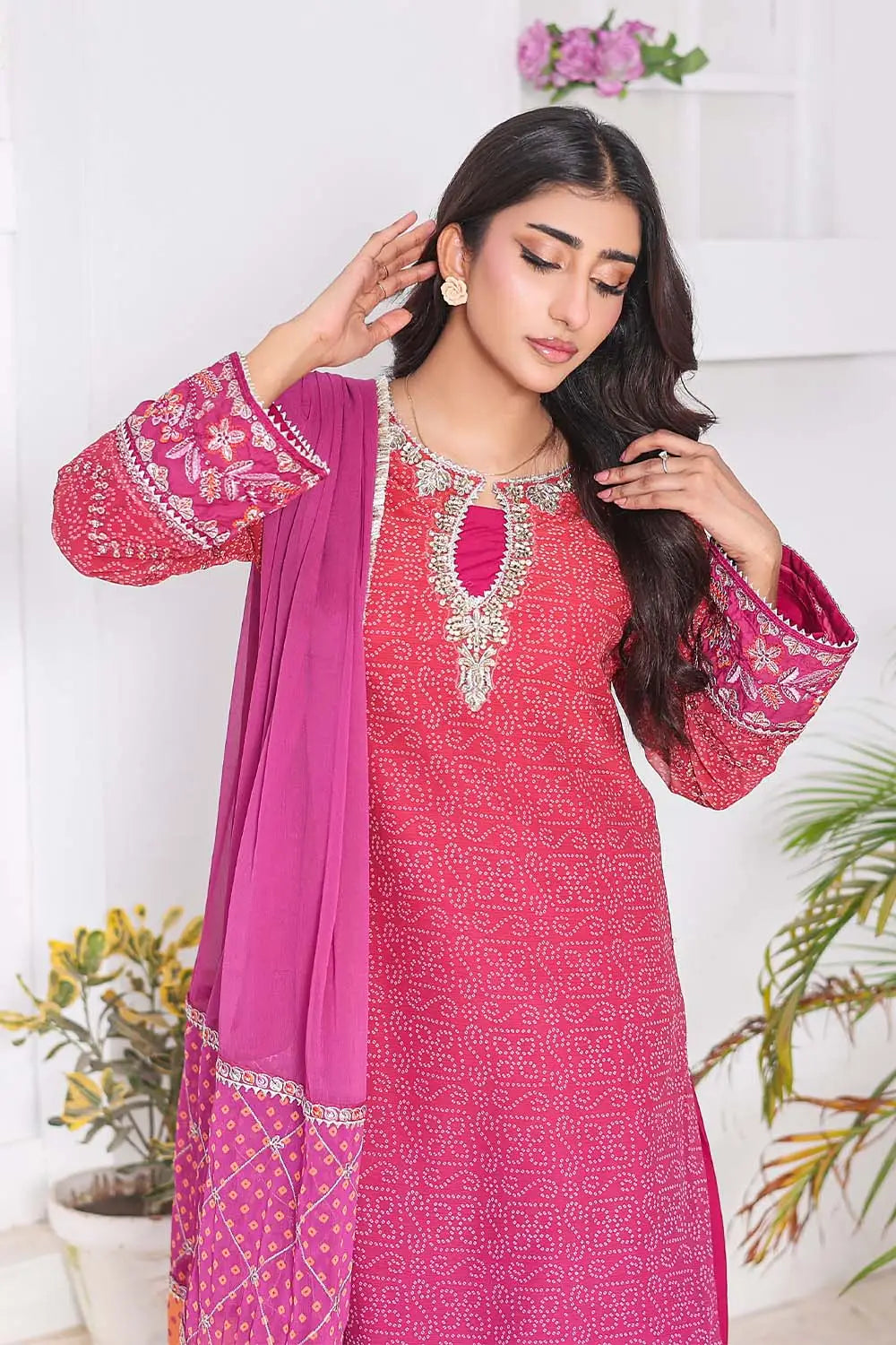 Shocking Pink three-piece women's suit featuring a Bandhani Chunri print short chiffon kurti with keyhole neckline, wide-flared crepe palazzo trousers, and chiffon dupatta with patchwork pallu.