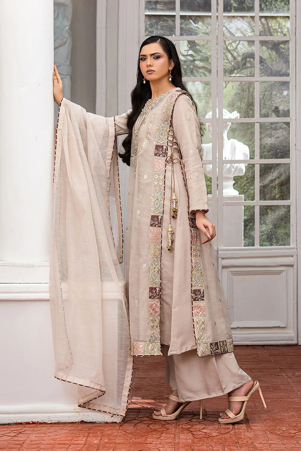 Taupe embroidered 4-piece Pakistani suit featuring a side dori style Khaddi Net overcoat with full lining, raw silk palazzo trousers, and a matching Khaddi Net dupatta.